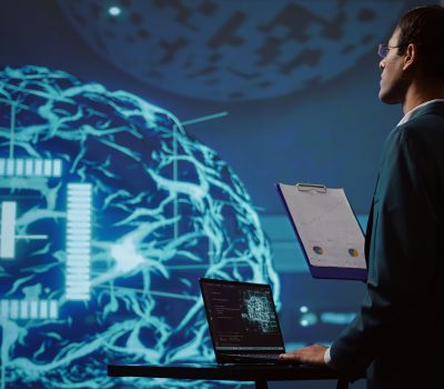 Startup employee looking over business charts, using AI software to take data driven decisions in tech industry. IT expert developing innovative artificial intelligence solutions for company, camera B